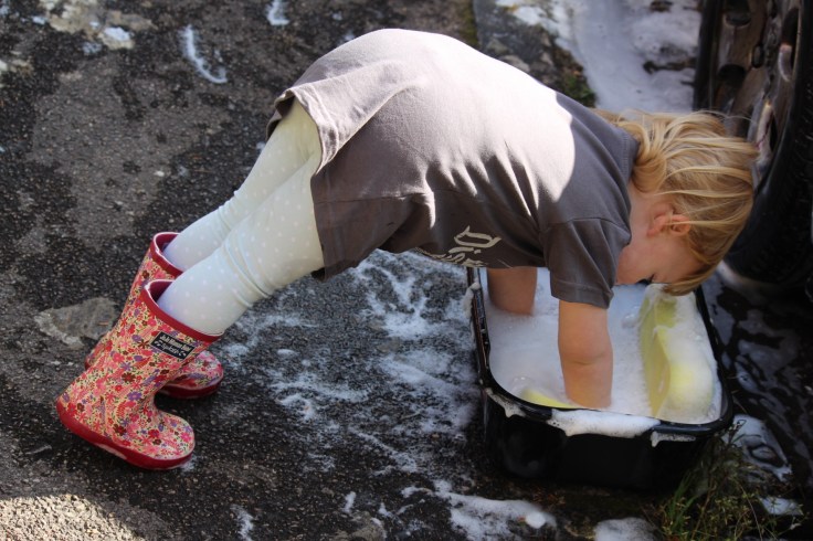Bella washing a car